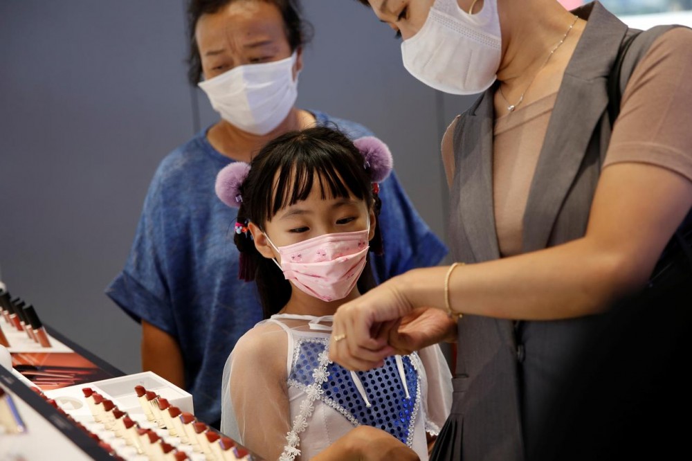 Customers wearing face masks shop at a Chinese cosmetics brand Perfect Diary store, following the coronavirus disease (COVID-19) outbreak in Beijing, China August 25, 2020. REUTERS/Tingshu Wang